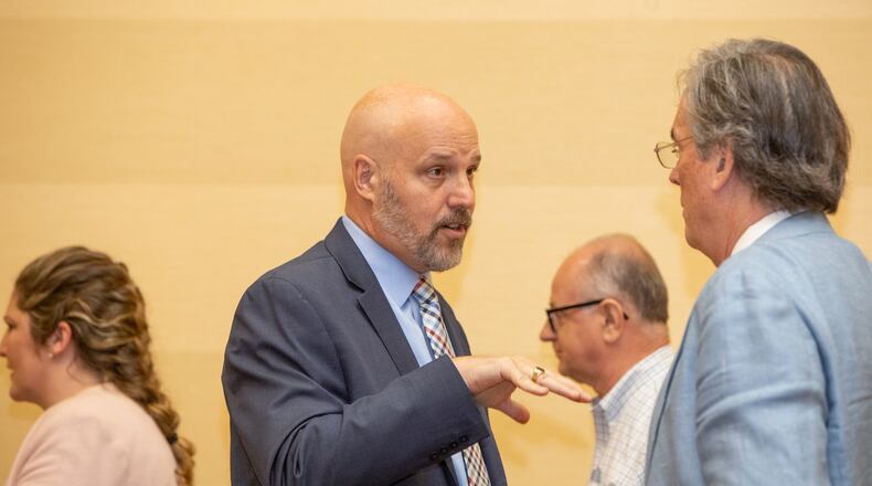 Michael Dombrowski, president of Thrive Attractions Management, center, waits for the Stone Mountain Memorial Association vote Monday, May 23, 2022 at the Evergreen Conference Center in the park. The board approved the change to use Thrive Attractions Management after protests and unrest has the previous company leaving the position. (Jenni Girtman for The Atlanta Journal-Constitution)