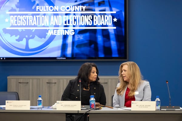 Fulton County Registration and Elections Board Chairperson Sherri Allen (left) talks with board member Julie Adams in 2024. (Ben Gray/AJC)