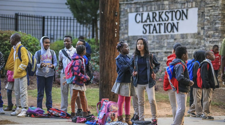 Students from Idlewood Elementary School wait for their bus in the 1000 block of Montreal Road in Clarkston on Thursday, April 19, 2018. JOHN SPINK/JSPINK@AJC.COM