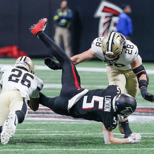 Falcons wide receiver Drake London (center) lands to the ground after a catch against the Saints at Mercedes-Benz Stadium on Sunday, Jan. 4, 2026. Atlanta takes on New Orleans in Week 4. (Miguel Martinez/AJC)