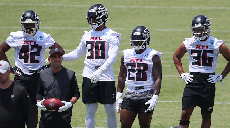 Falcons running backs Caleb Huntley (from left), Qadree Ollison, Mike Davis and Tony Brooks-James get in some work during organize team activities (OTAs) Tuesday, May 25, 2021, at the team training facility in Flowery Branch. (Curtis Compton / Curtis.Compton@ajc.com)