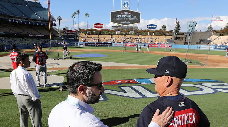 Braves general manager Alex Anthopoulos gives manager Brian Snitker a pat on the back before playing the Los Angeles Dodgers during Game 1 of the National League Division Series on Thursday, Oct 4, 2018, in Los Angeles. Curtis Compton/ccompton@ajc.com
