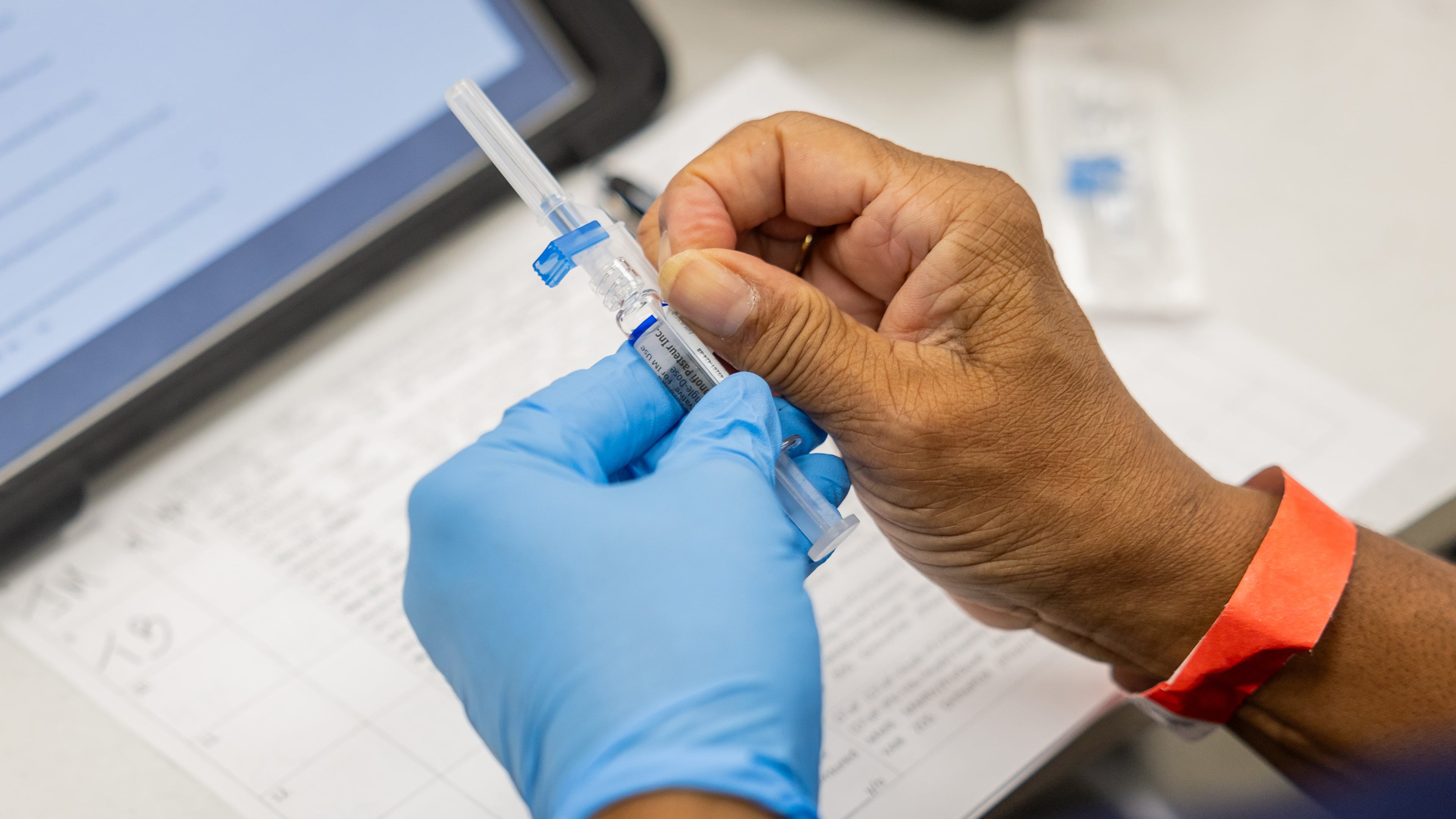 A nurse prepares to administer a flu shot ahead of last year's cold and flu season. This Saturday, you'll be able to get your vaccination without leaving your car. (Tess Crowley/Chicago Tribune/TNS)