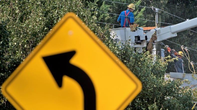 Power crews work to restore service on Hewatt Road in Lilburn on Wednesday. HYOSUB SHIN / HSHIN@AJC.COM