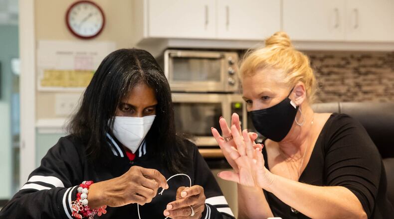Andrea Brown feels the heart that Leslie Eatherly, Director of Development, helped her create Tuesday afternoon at the Savannah Center for the Blind and Low Vision. Each participant was encouraged to create an expressive shape representing their emotional journey.