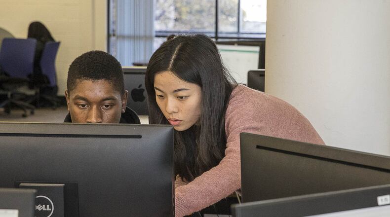 Georgia State University graduate student Ruixie Fang (right) answers a question from an undergraduate student taking a math final exam at the Mathematics Interactive Learning Environment Lab (MILE lab) at Georgia Sate University’s main campus in Altanta on Thursday, Dec. 6, 2018. ALYSSA POINTER / ALYSSA.POINTER@AJC.COM