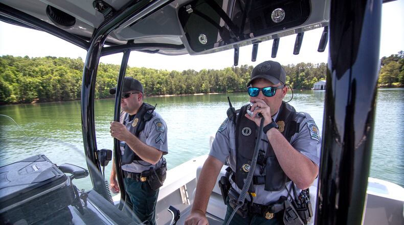 Game Warden Cpl. Dan Schay (left) and Game Warden 1st Class Kevin Goss head out on Lake Lanier for safety patrol on Friday, May 21, 2021.  (STEVE SCHAEFER for The Atlanta Journal-Constitution)