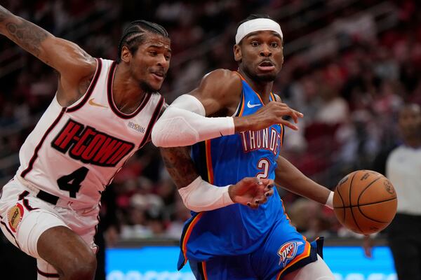 Houston Rockets guard Jalen Green (4) defends against Oklahoma City Thunder guard Shai Gilgeous-Alexander (2) during the first half of an NBA basketball game in Houston, Friday, April 4, 2025. (AP Photo/Ashley Landis)