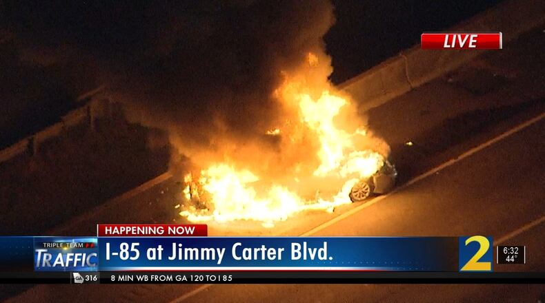 A Toyota Camry burst into flames on I-85 near the Jimmy Carter Boulevard exit Monday morning. The spot was the site of another crash and massive fire that shut down the interstate Saturday.