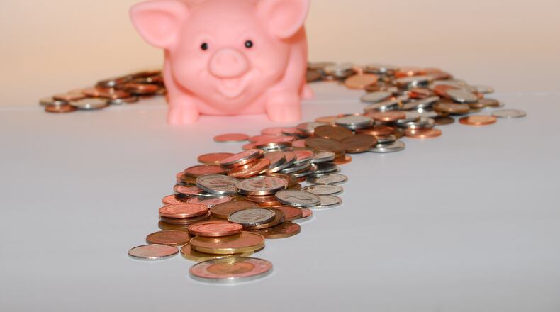 Many people go through their days without cash, but Americans still withdraw $700 billion a year from automated teller machines. (File photo)