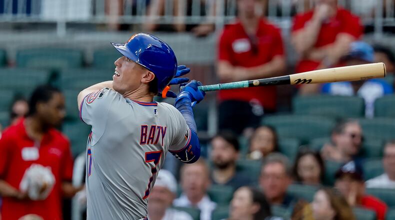 New York Mets' Brett Baty follows through on a grand slam against the Atlanta Braves during the first inning of a baseball game, Monday, Aug. 10, 2026, in Atlanta. (AP Photo/Erik S. Lesser)
