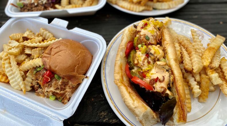 Grass VBQ joint serves wonderful vegan fare, like a smoked brat sandwich made with Beyond Meat sausage (left); a po’boy created from blue oyster mushrooms (right); a vegan, chopped  “veef” brisket sandwich (left rear) and a Nashville hot chic’n sandwich (right rear). 
Wendell Brock for The Atlanta Journal-Constitution