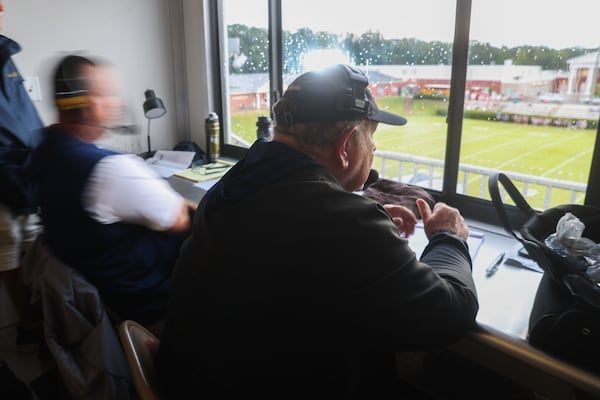 Putnam County assistant coach Charlie Winslette sits in the visiting coaches box at Morgan County High School in Madison, on Friday, Aug. 22, 2025. Winslette has been coaching high school football for 52 years. (Abbey Cutrer/AJC)