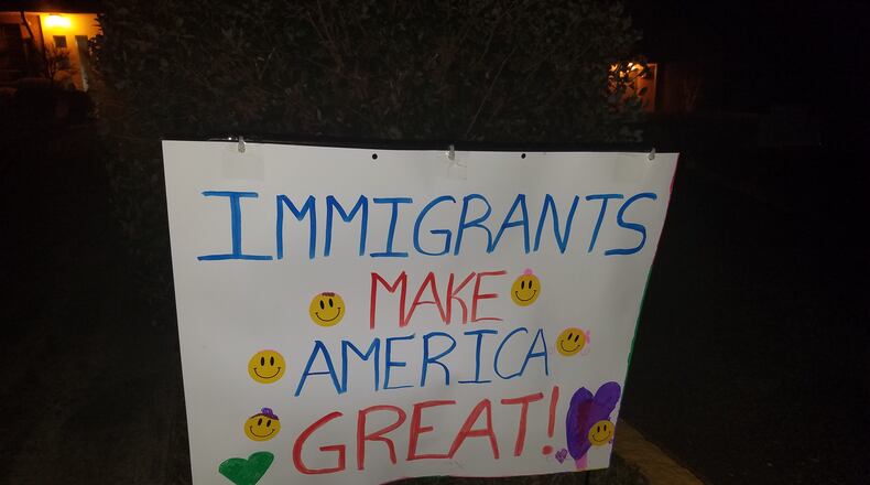 Dozens of signs lines the walkway to DeKalb County's International Community School late Sunday night.