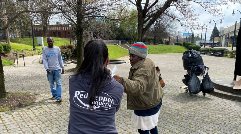 Red Pepper Taqueria employees worked to distribute meals to the homeless after the restaurant's Brookhaven location closed to comply with the city's ban on in-person dining earlier this week. COURTESY OF RED PEPPER TAQUERIA