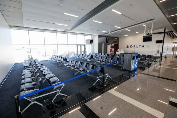 Starting Thursday, travelers assigned to Hartsfield-Jackson Atlanta International Airport gates D32-36 are in for a big surprise. Those gates now have high ceilings, large windows, extensive charging capability at seats and gleaming, large bathrooms. (Miguel Martinez/AJC)