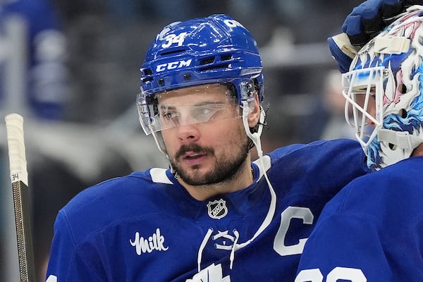 FILE - Toronto Maple Leafs centre Auston Matthews (34) consoles teammate Joseph Woll (60) in the final moments of the third period of Game 7 of a second-round NHL hockey playoff series in Toronto, May 18, 2025. (Frank Gunn/The Canadian Press via AP, File)