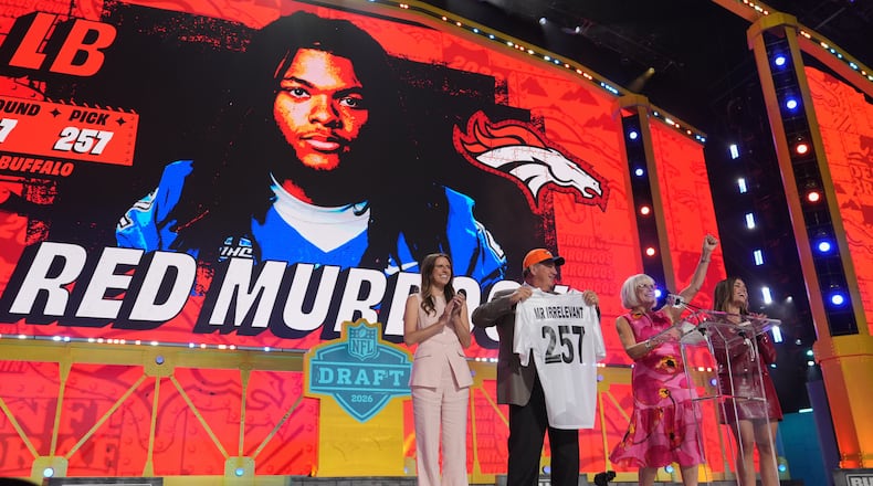 Melanie Salata Fitch, second from right announces Red Murdock as the final pick, referred to as Mr. Irrelevant, by the Denver Broncos, during third day of the NFL football draft, Saturday, April 25, 2026, in Pittsburgh. (AP Photo/Jeff Roberson)