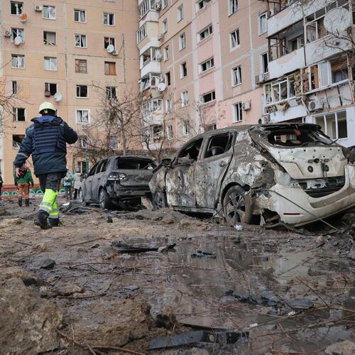 People pass by damaged cars near an apartment building after a Russian attack in Zaporizhzhia, Ukraine, Wednesday, Jan. 28, 2026. (AP Photo/Kateryna Klochko)