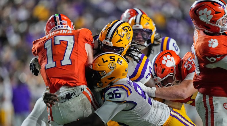 Clemson quarterback Christopher Vizzina (left) is sacked by LSU defensive tackles Dominick McKinley and Stephiylan Green in the first half of the NCAA football game, Saturday, Sept. 5, 2026 in Baton Rouge, La. (Gerald Herbert/AP)