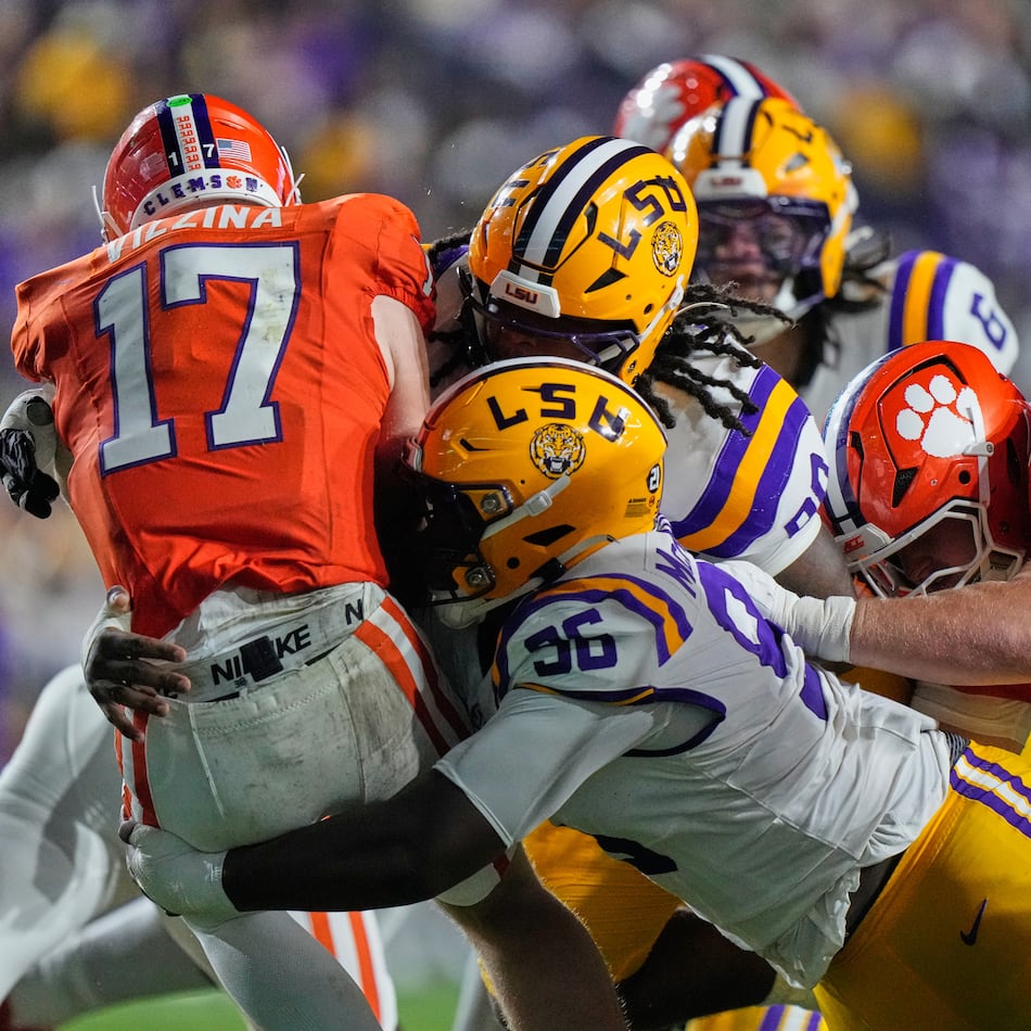 Clemson quarterback Christopher Vizzina (left) is sacked by LSU defensive tackles Dominick McKinley and Stephiylan Green in the first half of the NCAA football game, Saturday, Sept. 5, 2026 in Baton Rouge, La. (Gerald Herbert/AP)