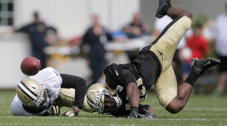 FILE - In this July 30, 2016, file photo, New Orleans Saints cornerback Delvin Breaux, right, breaks up a pass intended for wide receiver Reggie Bell during the NFL football team's training camp, in White Sulphur Springs, W. Va. After a recent decision to part ways with veteran Keenan Lewis, New Orleans' revamped defense is relying increasingly on first and second-year cornerbacks to slow down opposing receivers. (David Grunfeld/NOLA.com - The Times-Picayune via AP, File)