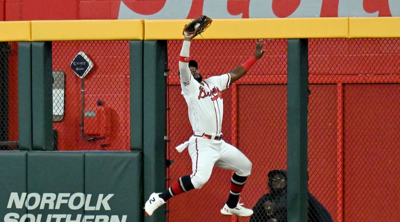 Braves center fielder Michael Harris II (23) makes a jump catch the fly ball by Philadelphia Phillies right fielder Nick Castellanos (8) into a double play to end the ninth inning in the Game 2 of the 2023 National League Division Series at Truist Park, Monday, October 9, 2023, in Atlanta. (Hyosub Shin / Hyosub.Shin@ajc.com)