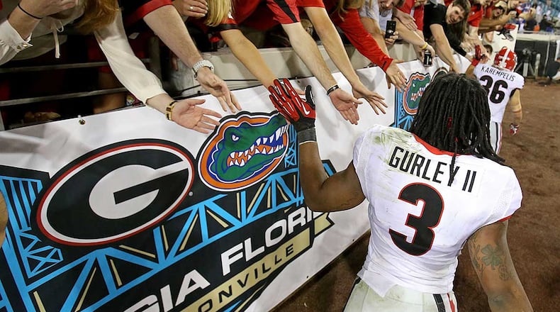 Georgia will wear white jerseys in Saturday's game against Florida, its first time in white jerseys against the Gators since the Todd Gurley-led Dogs won 23-20 in 2013. AJC file photo/Jason Getz