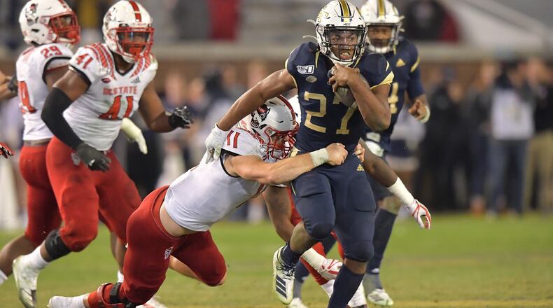 Georgia Tech running back Jordan Mason (27) eludes a tackle by North Carolina State linebacker Payton Wilson (11) at Bobby Dodd Stadium on Thursday, November 21, 2019.  (Hyosub Shin / Hyosub.Shin@ajc.com)