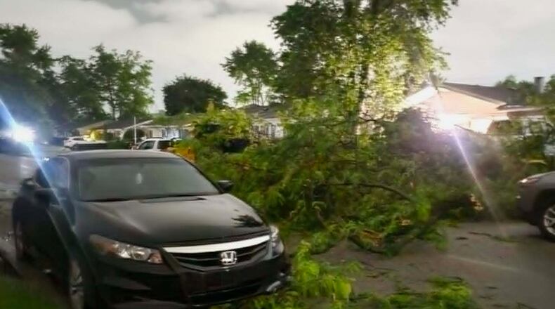 Damaged tree branches lie on a street in Elkhart, Ind., Thursday, June 11, 2026, following a severe weather system in the area. (Jennifer Hall via AP)