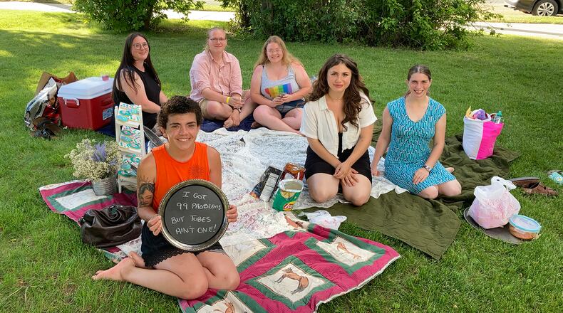 Dani Marietti (holding sign) and her friends gather for a “sterilization shower” in Helena, Montana, in July before Marietti was scheduled to have her fallopian tubes surgically removed. (Ellis Juhlin/Yellowstone Public Radio)