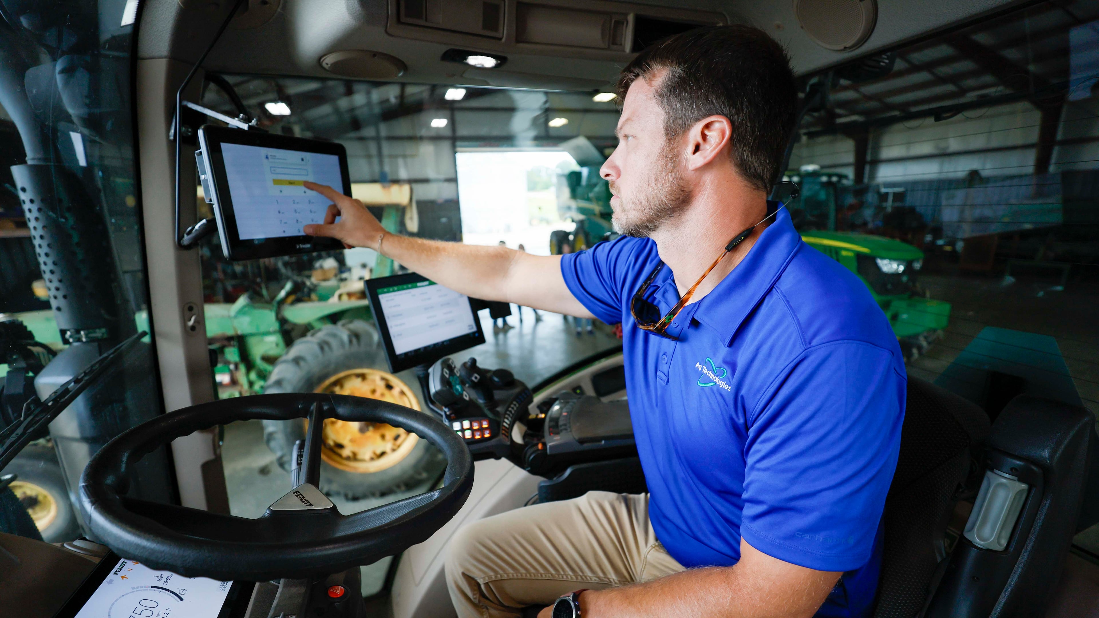 Travis Kelley, executive vice president of technology at Cordele-based farm equipment supplier Ag Technologies, demonstrates technology from Duluth-based AGCO Corp, Monday, Sept. 8, 2025. (Miguel Martinez/AJC)
