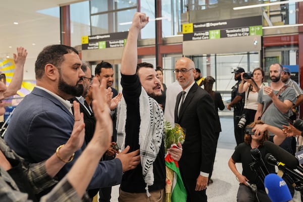 Mahmoud Khalil, center, reacts as he is greeted upon arriving at Newark International Airport, Saturday, June 21, 2025, in Newark, N.J. (AP Photo/Seth Wenig)