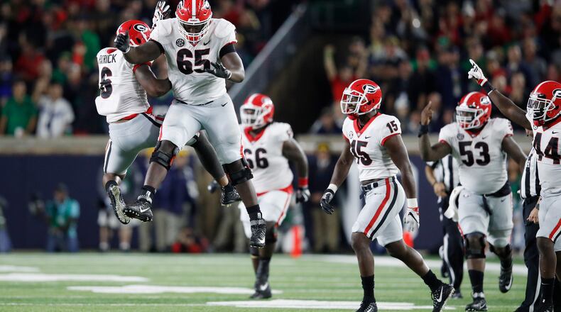 Kendall Baker (65) and Natrez Patrick (6) of the Georgia Bulldogs leap for joy after a big play in the fourth quarter. Photo by Joe Robbins/Getty Images)