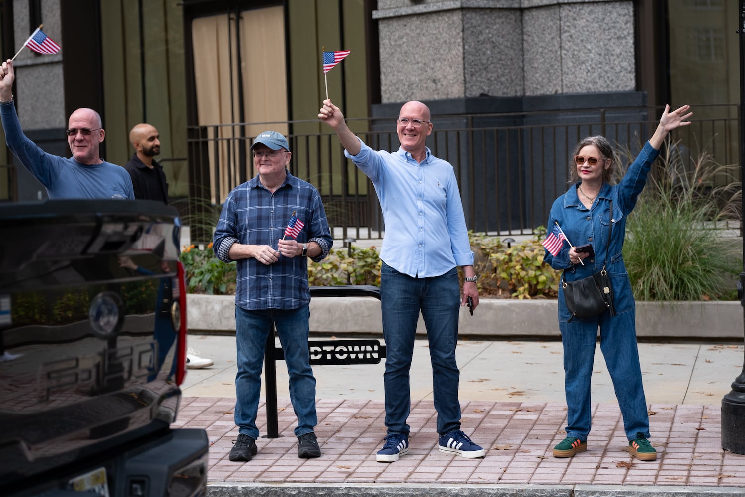 Spectators wave as the Georgia Veterans Day Parade passes by in Midtown Atlanta on Saturday, Nov. 8, 2025.   Ben Gray for the Atlanta Journal-Constitution