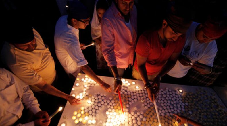 Worshipers in the Sikh community gather for a candle light vigil after prayer services at the Sikh Religious Society of Wisconsin, Monday, Aug. 6, 2012, in Brookfield, Wis., a day after a gunman killed six Sikh worshipers, before being shot and killed himself by police at Sikh Temple Wisconsin in Oak Creek, Wis.