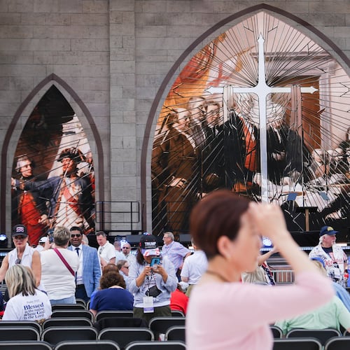 A person prays during Rededicate 250, a mostly conservative Christian prayer gathering in honor of the United States' 250th anniversary, on the National Mall, Sunday, May 17, 2026, in Washington. (AP Photo/Julia Demaree Nikhinson)