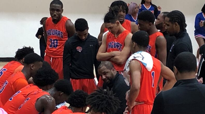 Coach L’Dreco Thomas talks to his Cedar Shoals team during a timeout.