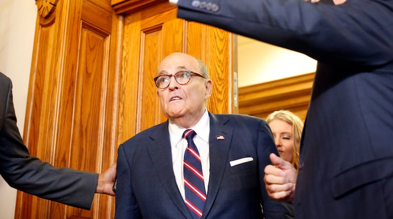 Rudy Giuliani walks to a senate hearing at the Georgia State Capitol in Atlanta on Thursday, December 3, 2020. The Georgia Senate Committee on Judiciary has formed a special subcommittee to take testimony of elections improprieties and evaluate the election process. (Rebecca Wright for the Atlanta Journal-Constitution)
