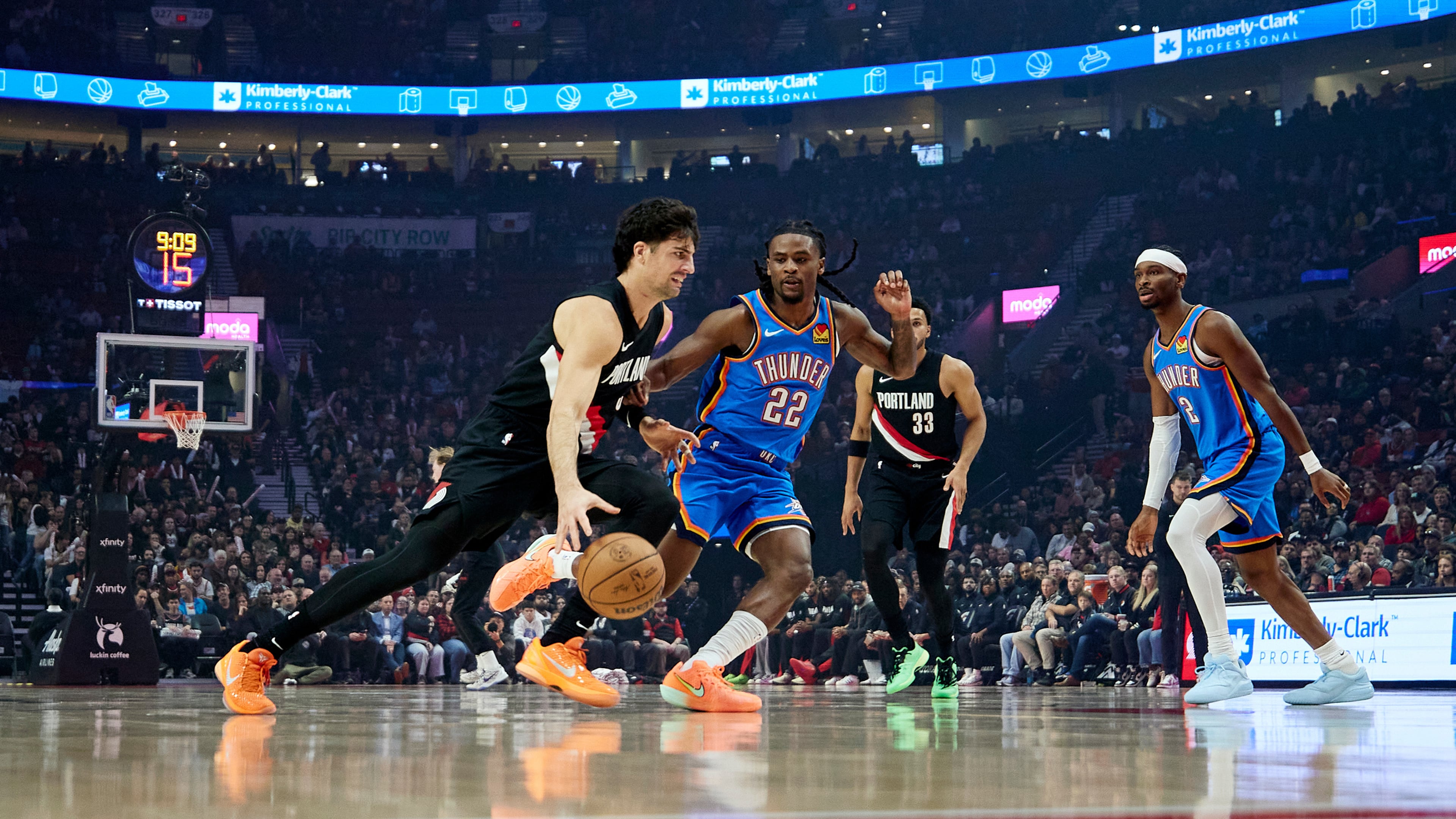 Portland Trail Blazers forward Deni Avdija, left, dribbles past Oklahoma City Thunder guard Cason Wallace during the first half of an NBA basketball game in Portland, Ore., Wednesday, Nov. 5, 2025. (AP Photo/Craig Mitchelldyer)