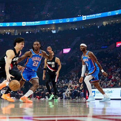 Portland Trail Blazers forward Deni Avdija, left, dribbles past Oklahoma City Thunder guard Cason Wallace during the first half of an NBA basketball game in Portland, Ore., Wednesday, Nov. 5, 2025. (AP Photo/Craig Mitchelldyer)