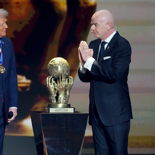 FIFA President Gianni Infantino, right, awards President Donald Trump with the FIFA Peace Prize during the draw for the 2026 soccer World Cup at the Kennedy Center in Washington, Friday, Dec. 5, 2025. (AP Photo/Chris Carlson)