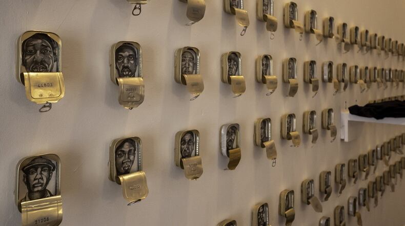 Tight Packers/Photo caption: Atlanta artist Masud Olufani’s “Translocation & Transfiguration” exhibition at Hammonds House Museum examines the idea of blackness in works like “Tight Packers.” Photo credit: Michael Moss