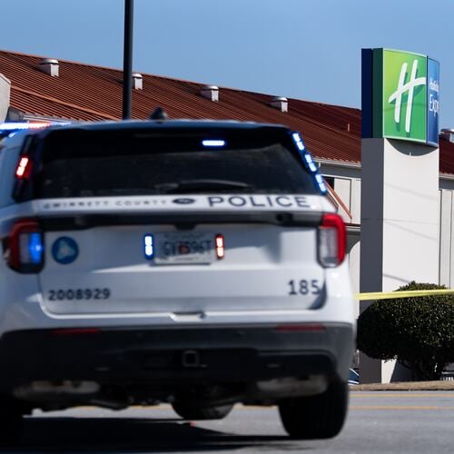 A Gwinnett County police vehicle sits at the scene of the officer-involved shooting at a Holiday Inn Express on East Park Place Boulevard near Stone Mountain on Sunday. Feb. 1, 2026. (Ben Hendren for the AJC)