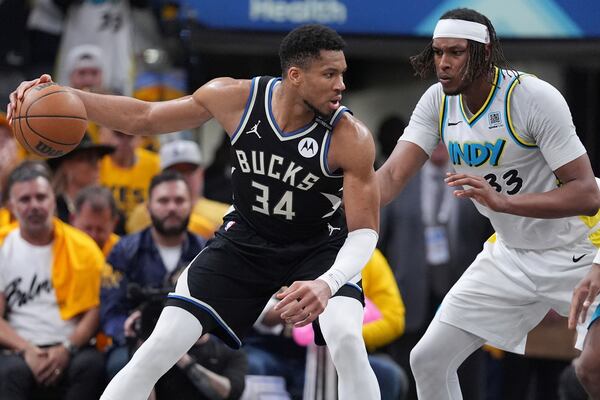 Milwaukee Bucks forward Giannis Antetokounmpo (34) dribbles the ball against Indiana Pacers center Myles Turner (33) during the second half in Game 5 of an NBA basketball first-round playoff series in Indianapolis, Tuesday, April 29, 2025. (AP Photo/Michael Conroy)