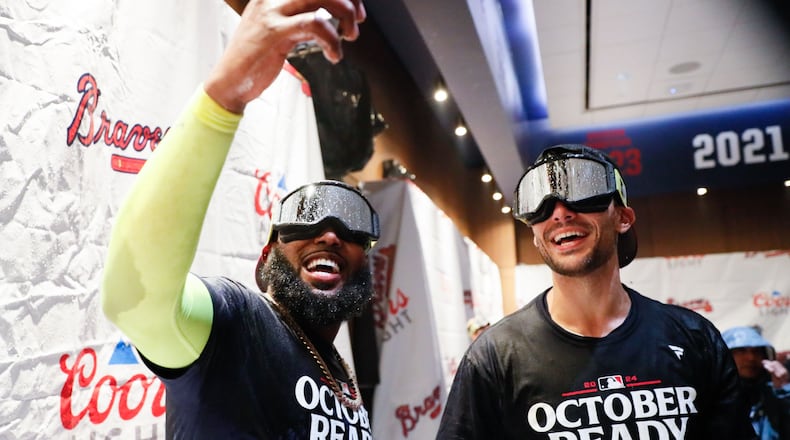 Atlanta Braves designated hitter Marcell Ozuna (20) takes a selfie with Matt Olson (28) in the locker rooms.
(Miguel Martinez/ AJC)