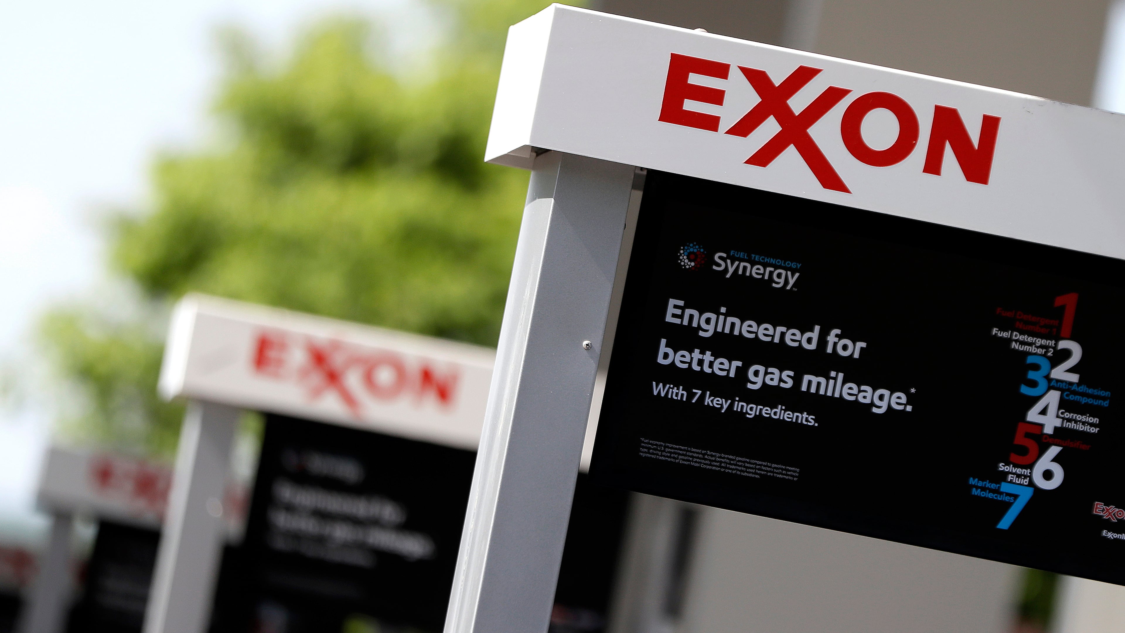 FILE- This April 25, 2017, file photo, shows Exxon service station signs in Nashville, Tenn.  (AP Photo/Mark Humphrey, File)