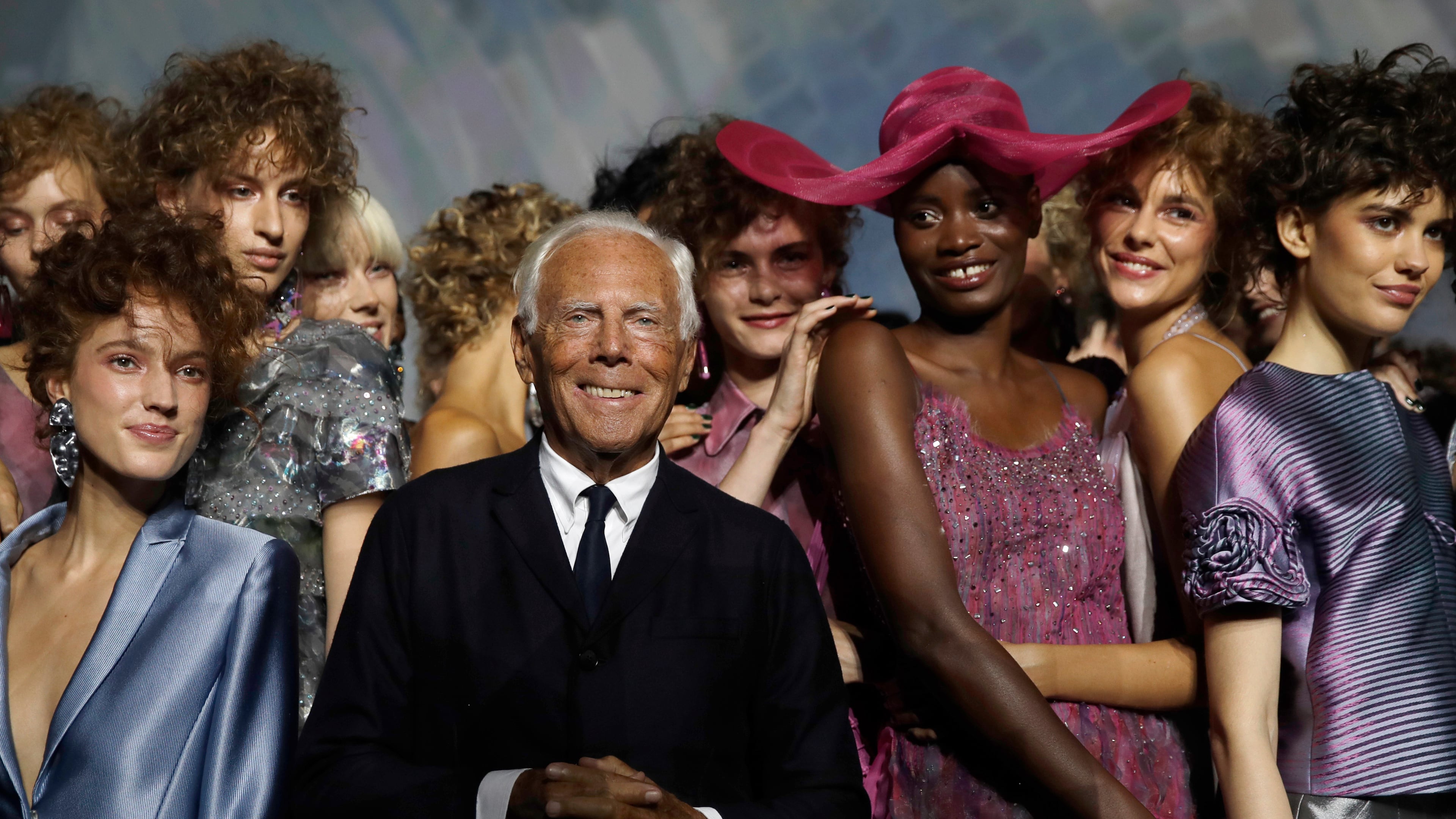 FILE - Designer Giorgio Armani, centre, poses with models at the end of his women's 2019 Spring-Summer collection, unveiled during the Fashion Week in Milan, Italy, Sunday, Sept. 23, 2018. (AP Photo/Luca Bruno, File)