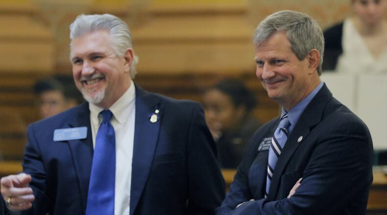 Feb. 24 2017 - Atlanta - Sen. Ben Watson (right) confers with Senator Greg Kirk in the Senate. The coastal Georgia senator whose medical company could benefit from opening an outpatient surgery center has introduced a bill that would allow him to do just that. The state’s nonprofit and rural hospitals protest that relaxing the law to allow such private surgeries could suck away one of their last profitable services. Watson said he has backed off the issue for now. The 24th day of the Georgia General Assembly. BOB ANDRES /BANDRES@AJC.COM