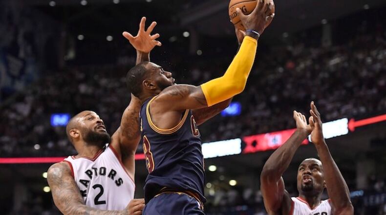 Cleveland Cavaliers forward LeBron James (23) goes to the net past Toronto Raptors forwards P.J. Tucker (2) and Serge Ibaka (9) during the second half of Game 4 of a second-round NBA basketball playoff series in Toronto, Sunday, May 7, 2017. (Frank Gunn/The Canadian Press via AP)
